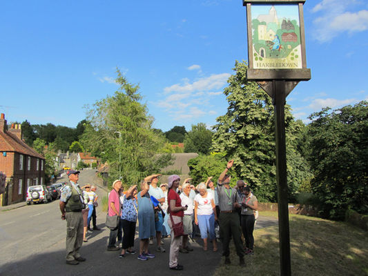 Peter Berg, our guide, with Canterbury Branch members at the Harbledown Village sign